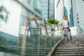 young diverse businessman walking down steps outside