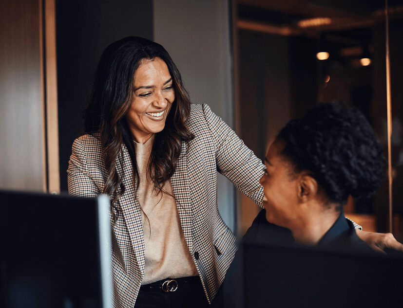 Co workers laughing together in office