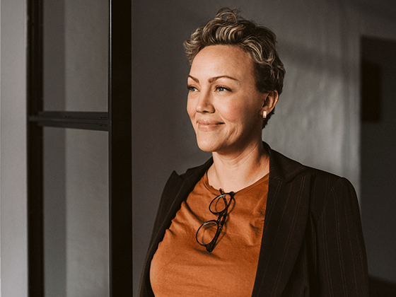 smiling businesswoman standing while looking away